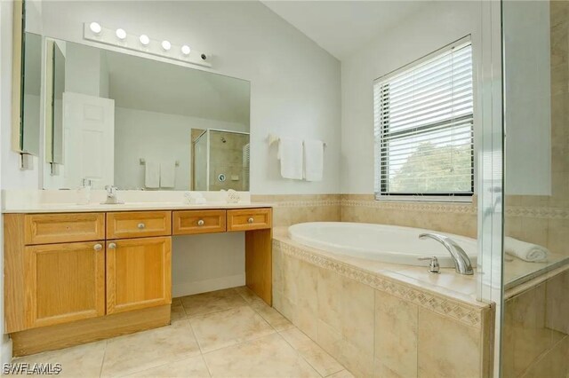 bathroom featuring separate shower and tub, vanity, and tile patterned flooring