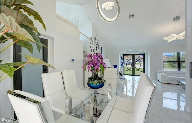 dining room with french doors and a chandelier