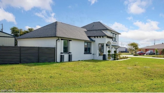 view of side of property with a lawn