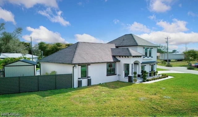 rear view of house featuring a lawn