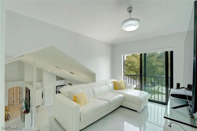 living room featuring lofted ceiling