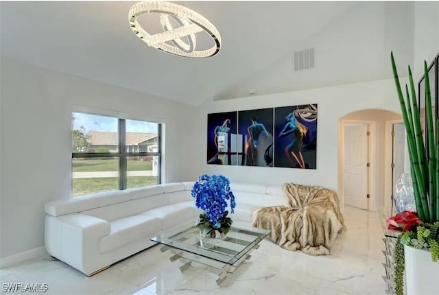 living room featuring a chandelier and lofted ceiling