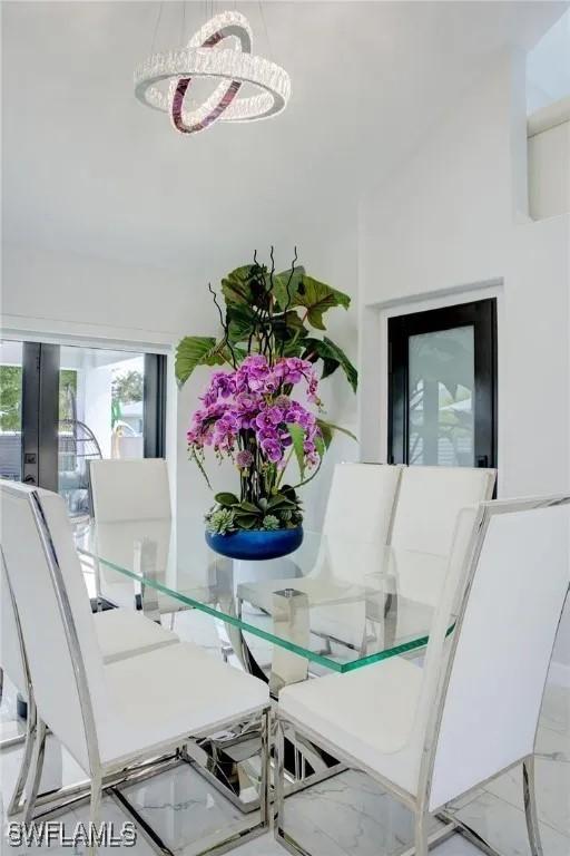 dining area featuring french doors and an inviting chandelier