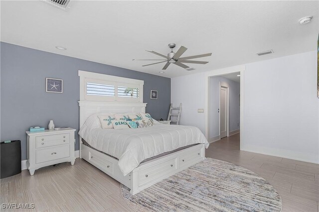 bedroom with ceiling fan and light hardwood / wood-style floors