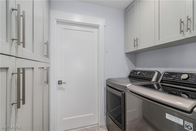 laundry area with cabinets and independent washer and dryer