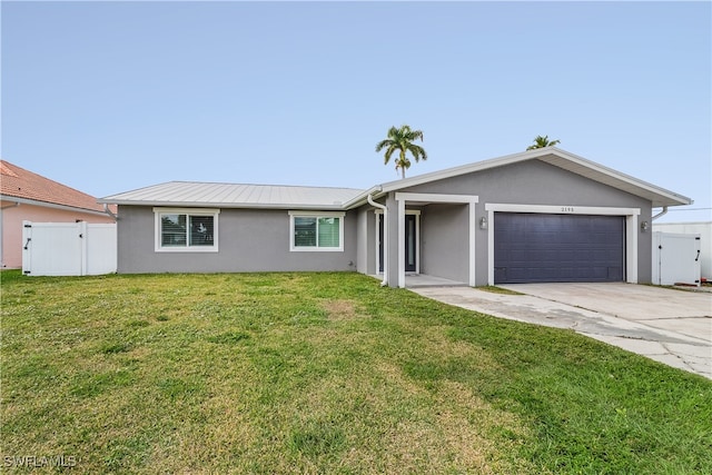 single story home with a front yard and a garage