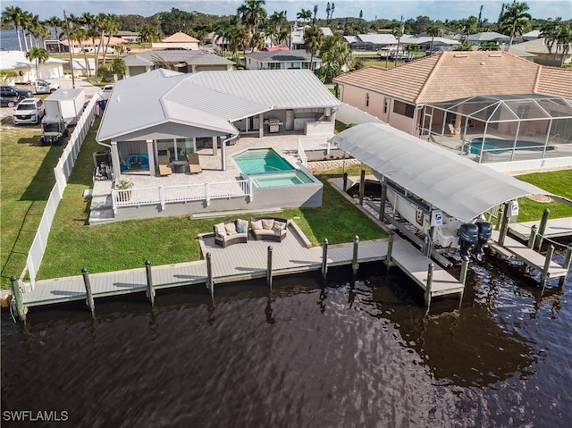 view of dock featuring a yard, an outdoor hangout area, a water view, and a patio area