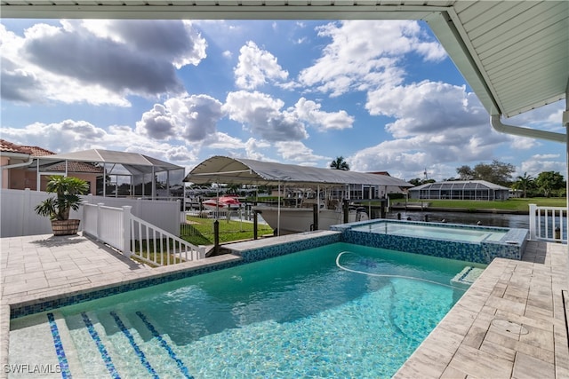 view of swimming pool with a water view, an in ground hot tub, and a patio