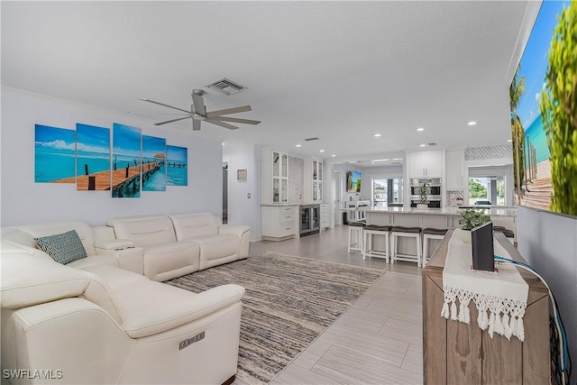 living room with beverage cooler and ceiling fan