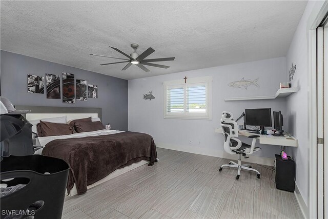 bedroom featuring a textured ceiling and ceiling fan