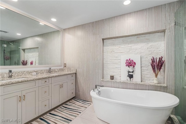 bathroom featuring shower with separate bathtub and vanity