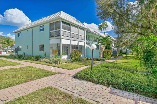 view of property exterior with a yard