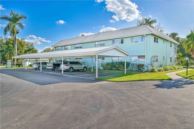 view of vehicle parking with a yard