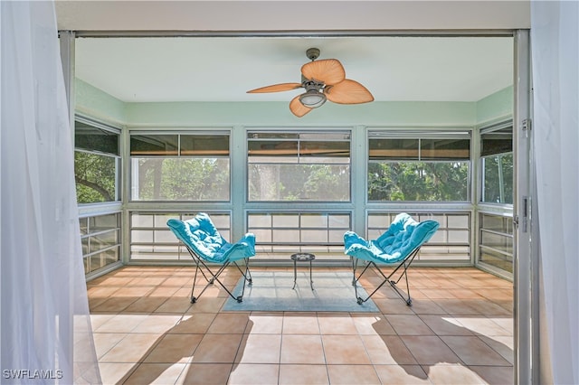 unfurnished sunroom with ceiling fan