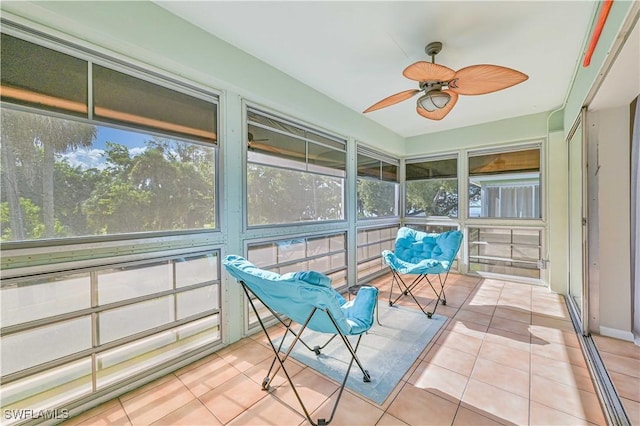 sunroom / solarium featuring ceiling fan