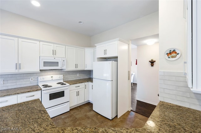 kitchen featuring white appliances, white cabinetry, dark wood-type flooring, and dark stone countertops