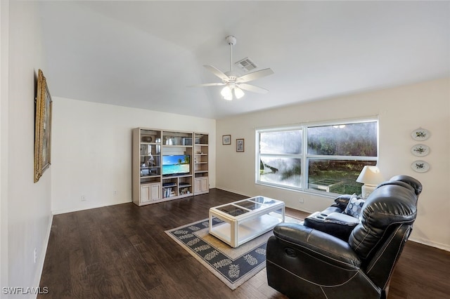 living room featuring ceiling fan and dark hardwood / wood-style floors