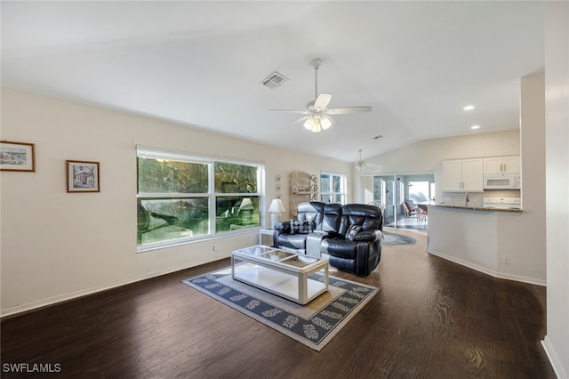 living room featuring dark hardwood / wood-style floors, ceiling fan, and lofted ceiling