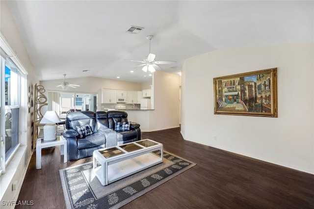 living room with ceiling fan, dark wood-type flooring, and vaulted ceiling