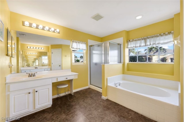 bathroom with vanity and independent shower and bath