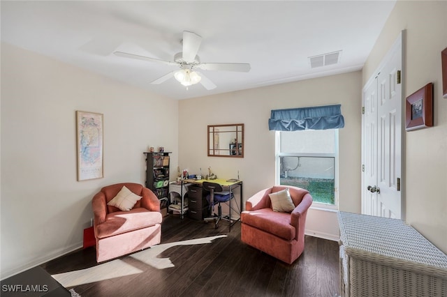 sitting room with ceiling fan and dark hardwood / wood-style flooring