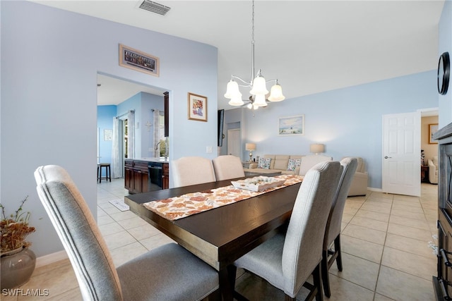 dining room featuring light tile patterned floors and an inviting chandelier