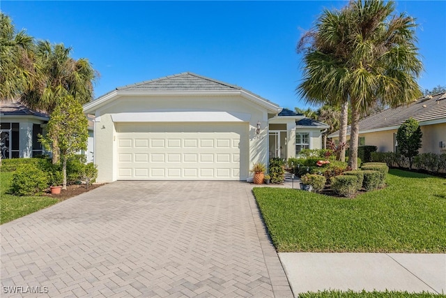 single story home with a garage and a front yard