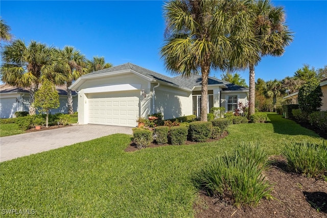 ranch-style home with a garage and a front lawn