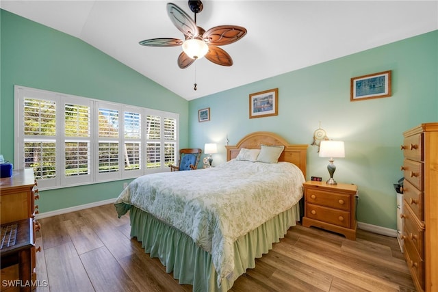 bedroom featuring hardwood / wood-style flooring, ceiling fan, and lofted ceiling