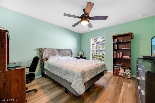 bedroom with ceiling fan and light hardwood / wood-style floors