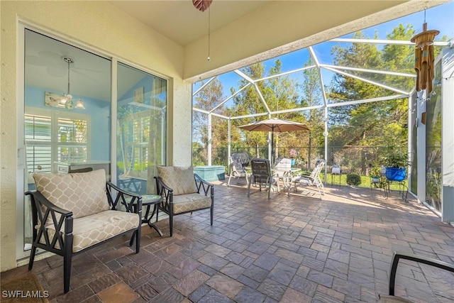 view of patio with glass enclosure