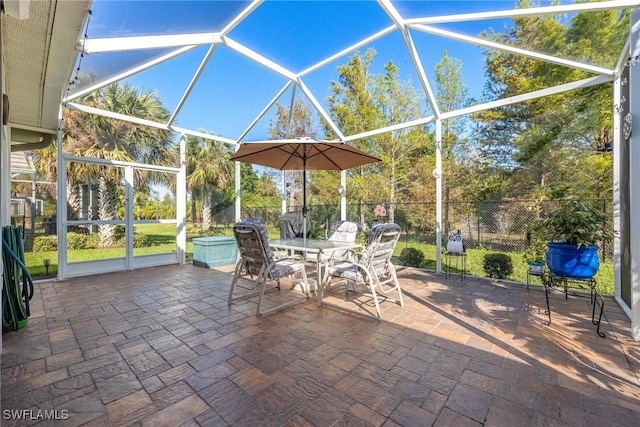 view of patio featuring a lanai