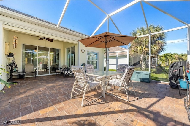 view of patio featuring glass enclosure and ceiling fan