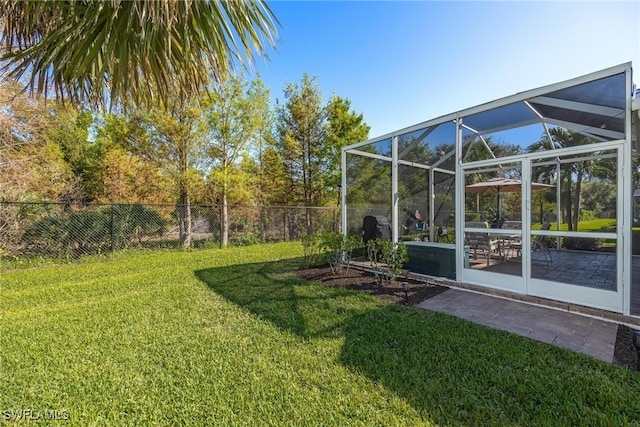 view of yard with glass enclosure