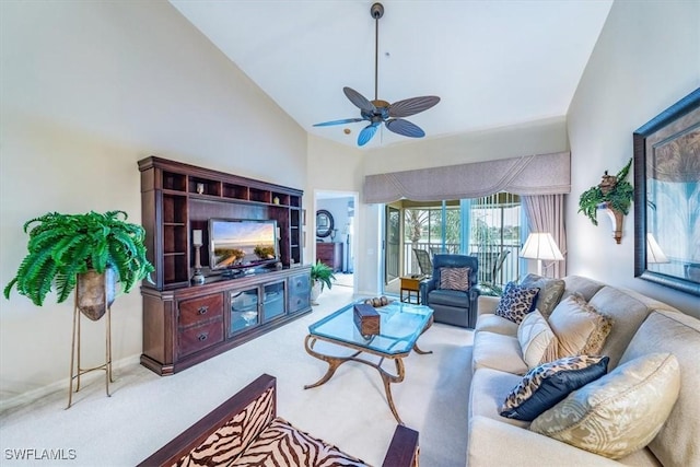 carpeted living area featuring baseboards, a ceiling fan, and high vaulted ceiling