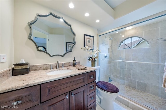 bathroom featuring vanity, toilet, and walk in shower