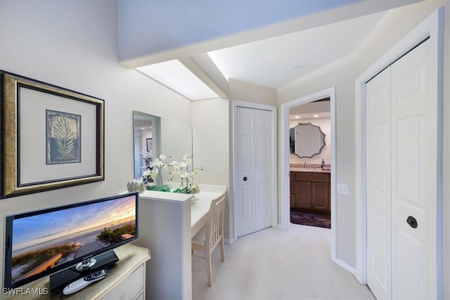 hallway featuring light colored carpet