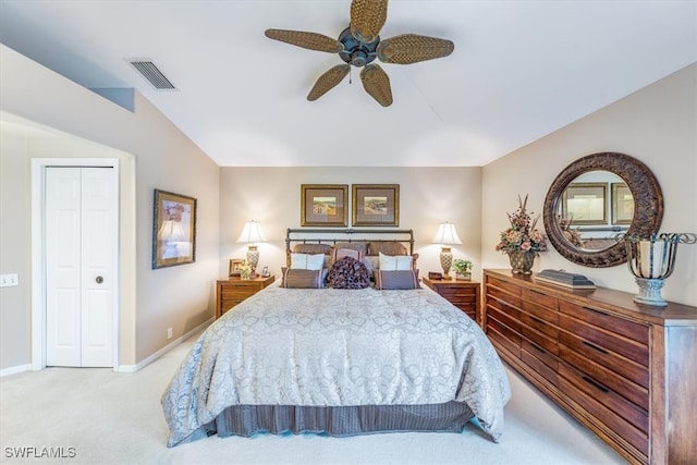 bedroom featuring a closet, light colored carpet, and ceiling fan