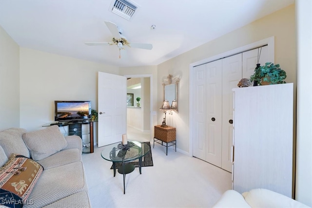 carpeted living room featuring ceiling fan