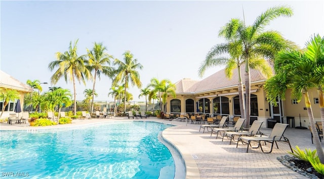 pool featuring fence and a patio