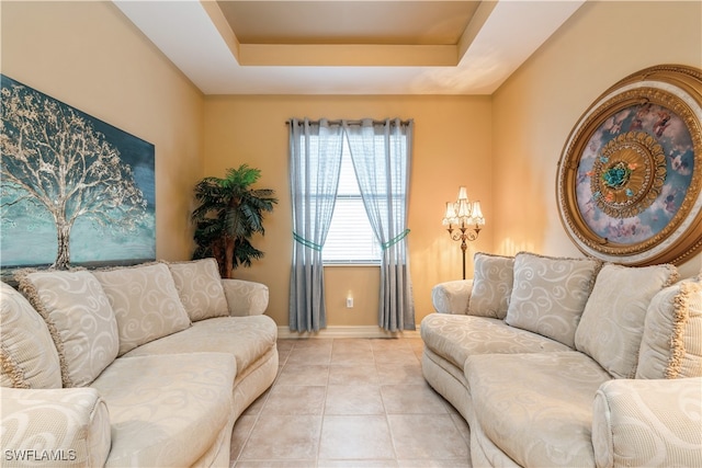 tiled living room featuring a tray ceiling