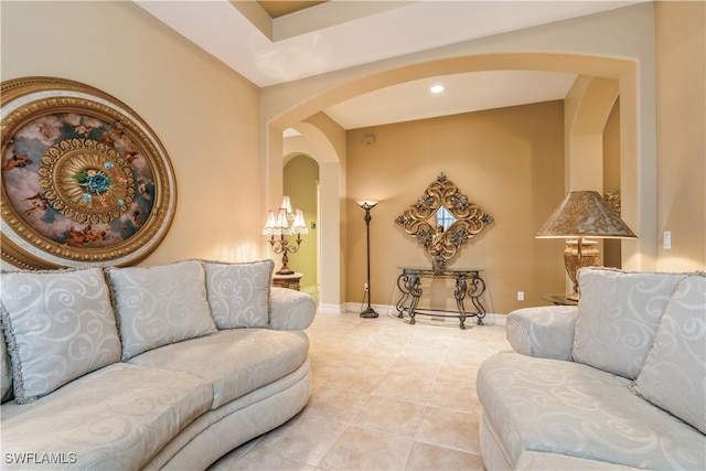 living room with a notable chandelier and light tile patterned floors