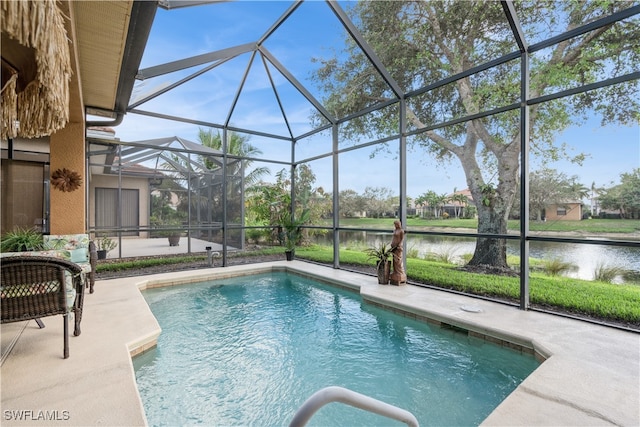 view of swimming pool featuring glass enclosure, a water view, and a patio