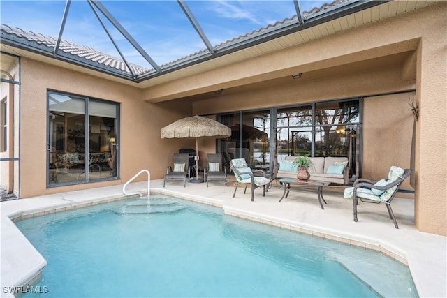 view of pool featuring glass enclosure and a patio