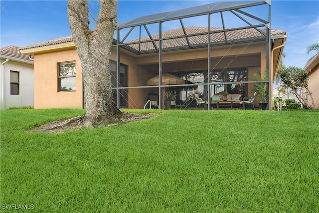 rear view of house featuring a yard and a lanai