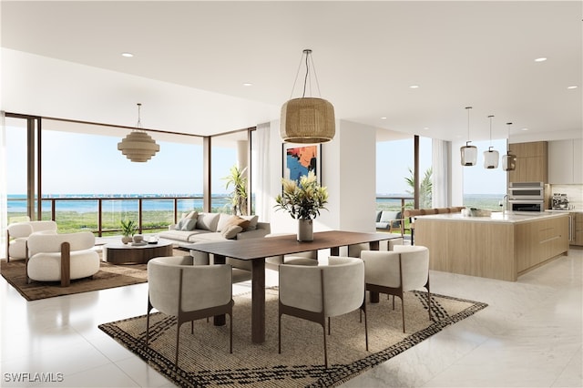 dining area with a water view and a wealth of natural light