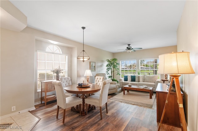 dining space with ceiling fan and dark hardwood / wood-style flooring