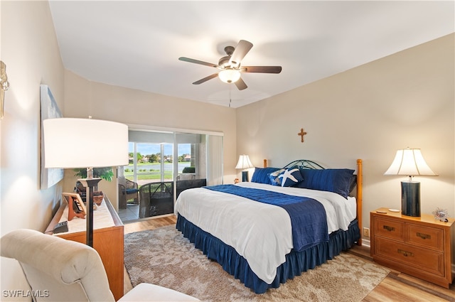 bedroom featuring access to exterior, light hardwood / wood-style floors, and ceiling fan