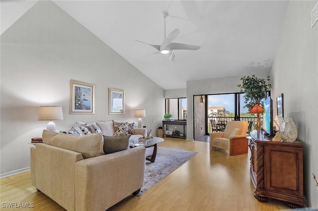 living room with ceiling fan, high vaulted ceiling, and light hardwood / wood-style floors