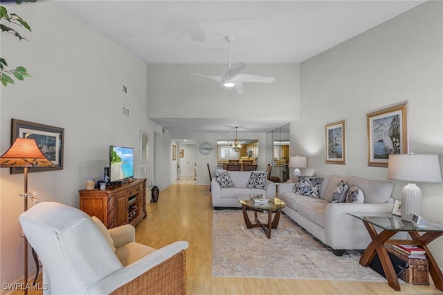 living room with light hardwood / wood-style flooring and ceiling fan